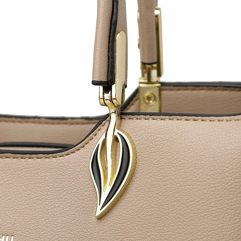 Women's black PU messenger bag with adjustable strap and three internal compartments for organised storage