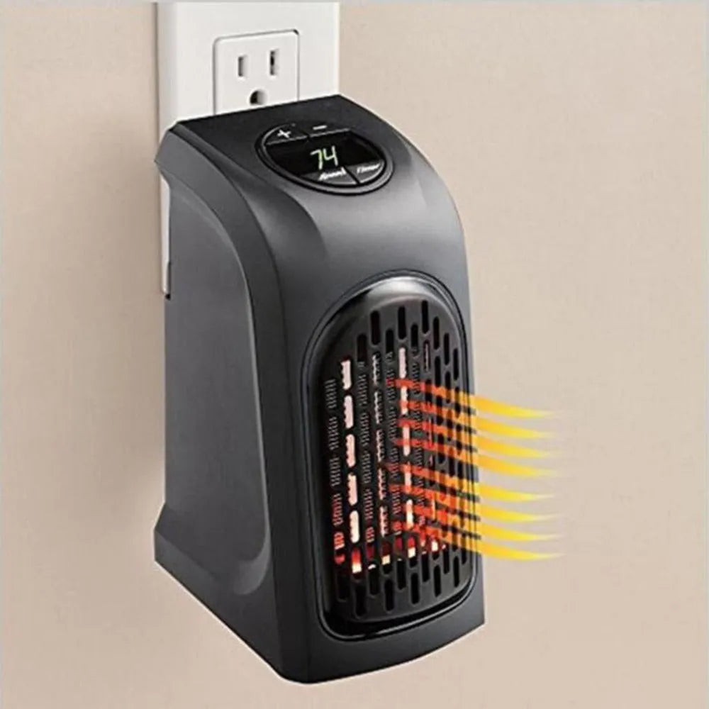 Small black ceramic fan heater with mechanical controls on a desk.