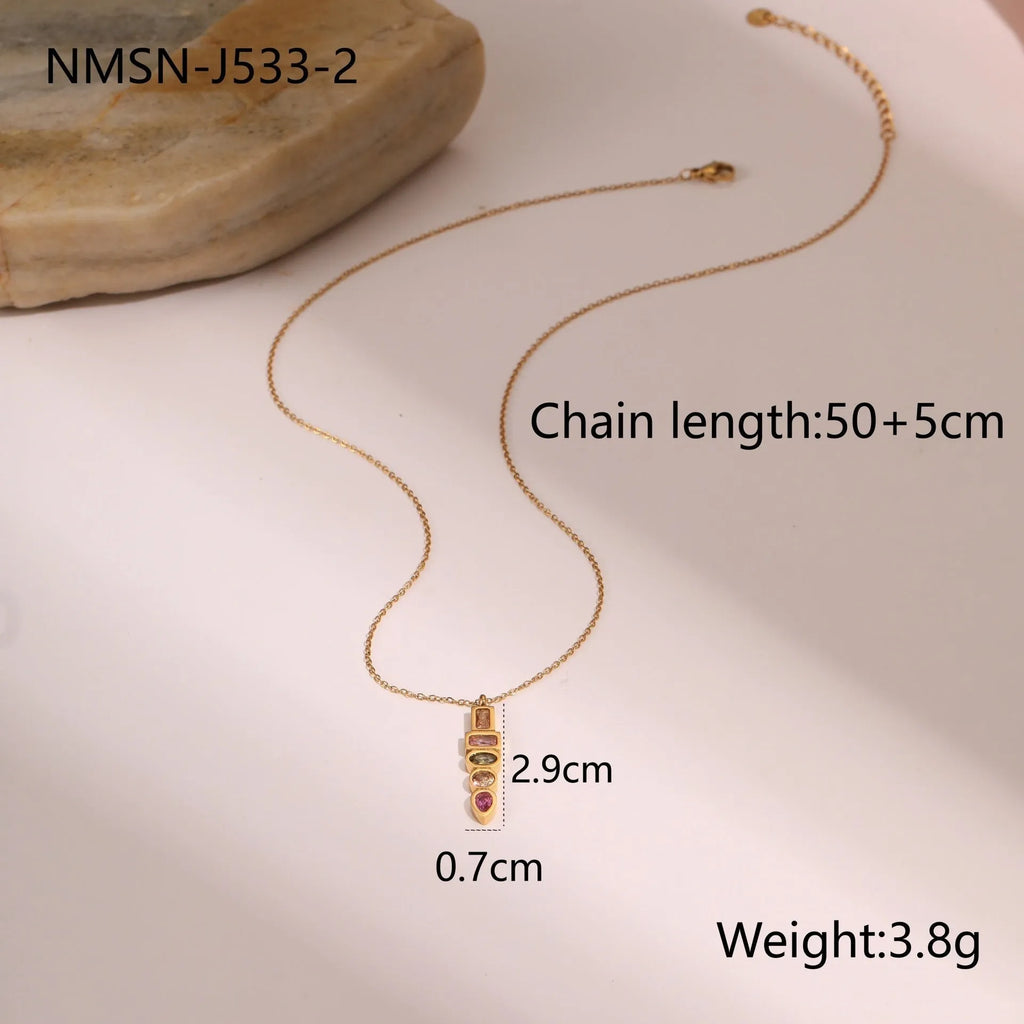 Geometric gold-plated stainless steel jewellery set featuring a necklace, ring, and earrings on a white background.