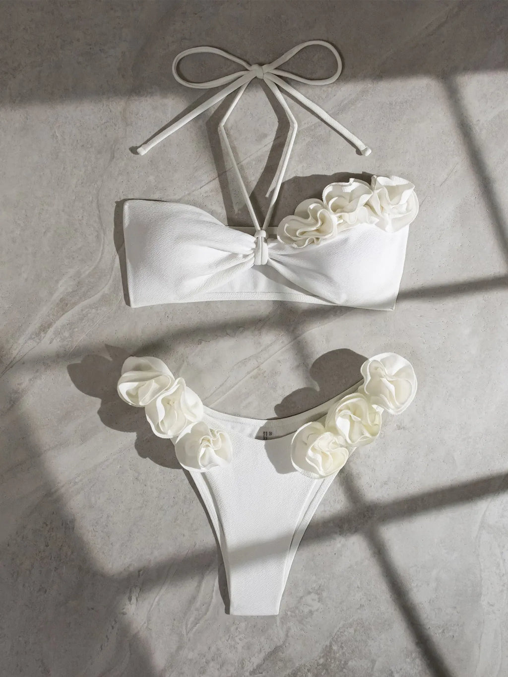 White halter neck bikini with lace-up back and three-dimensional flower detailing for swimming
