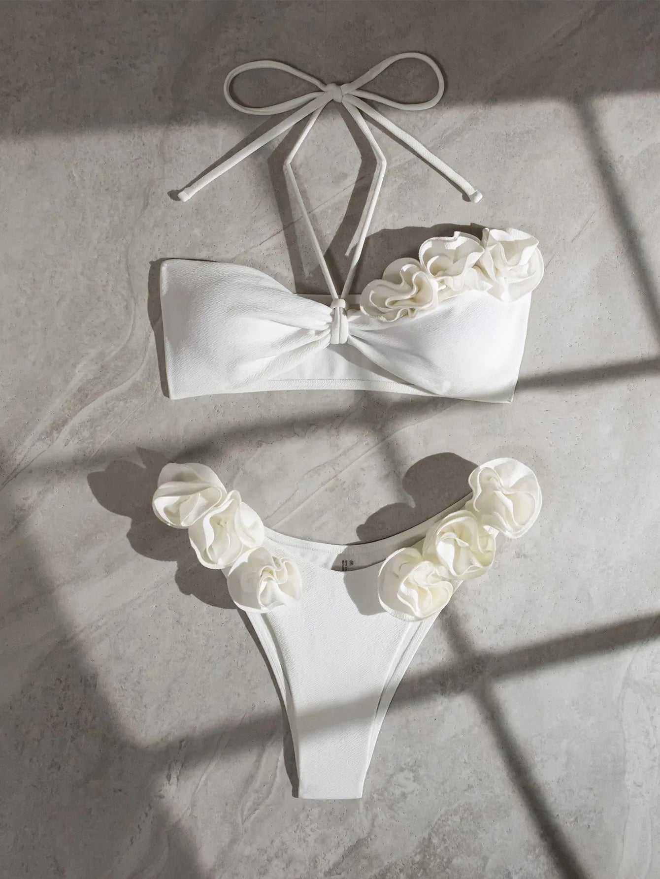 White halter neck bikini with lace-up back and three-dimensional flower detailing for swimming