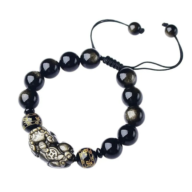 Hand-woven Golden Obsidian Pi Xiu bracelet with animal charm on wrist, showing bead detail.