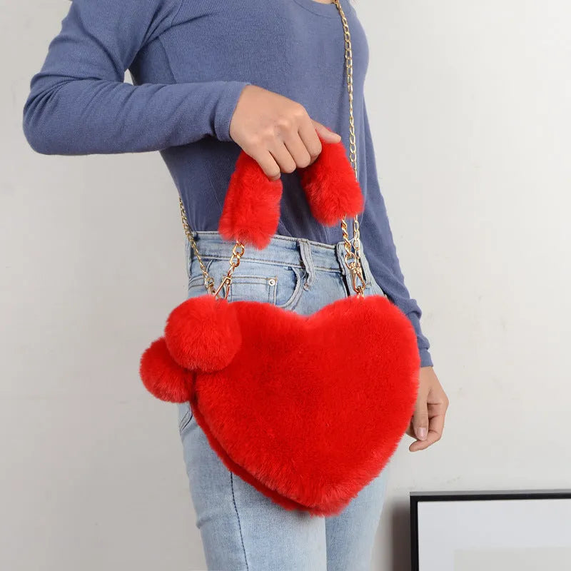 Women's plush heart-shaped handbag with single adjustable strap in various solid colours