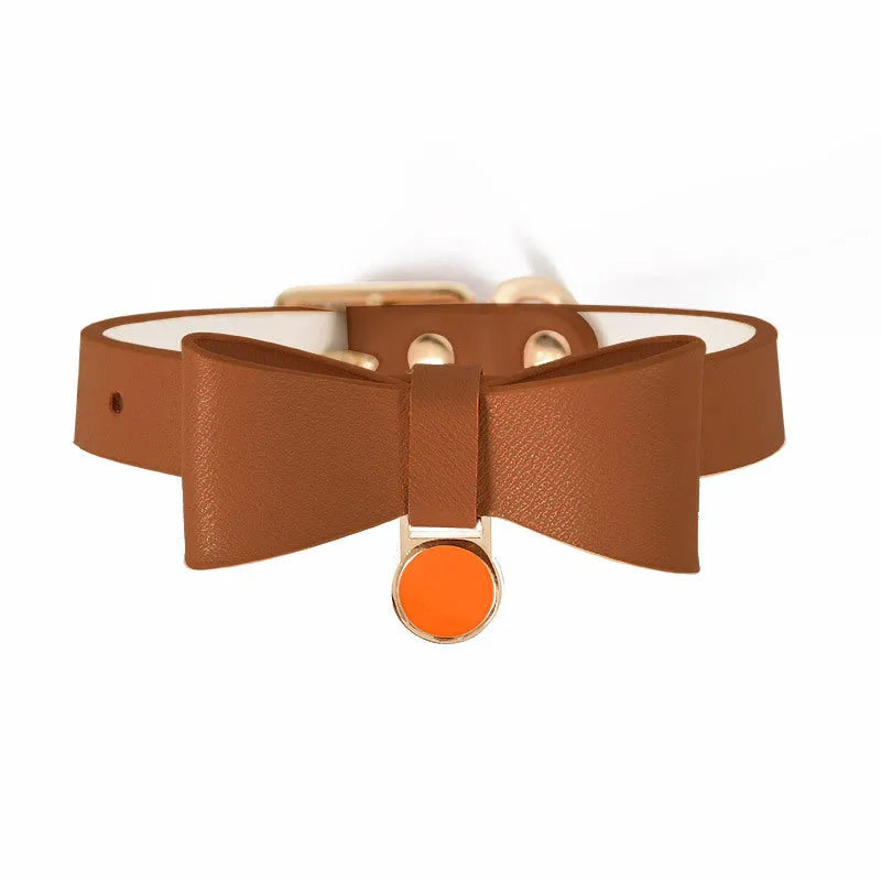Brown leather cat collar with a silver buckle on an adjustable strap.