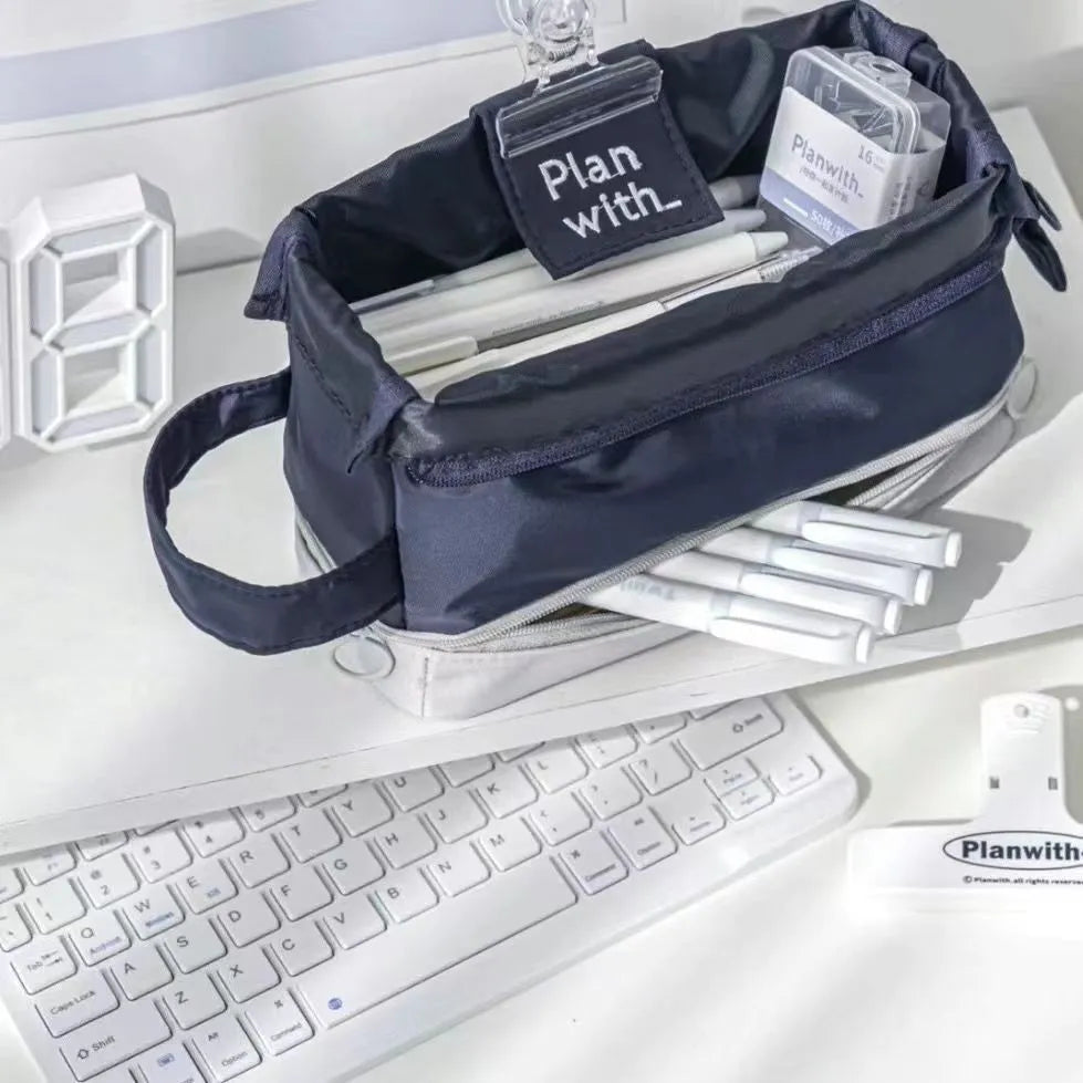 Dark blue double-layer folding pencil case showing six interior compartments for stationery organisation