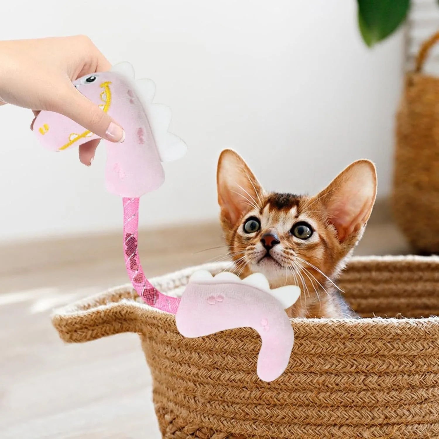 Four plush cat chew toys in pink, purple, and yellow colours showing mouse, fish, bunny, and catnip designs