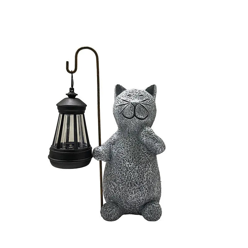 Solar garden light featuring a resin sculpture of a kitten holding up a lantern.