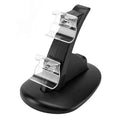 Black dual charging stand holding two Xbox One gamepad controllers.