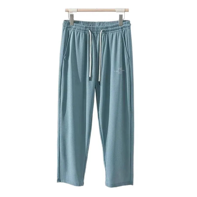 Men's loose straight-leg trousers with elastic mesh panels and ankle tie in black ice silk fabric