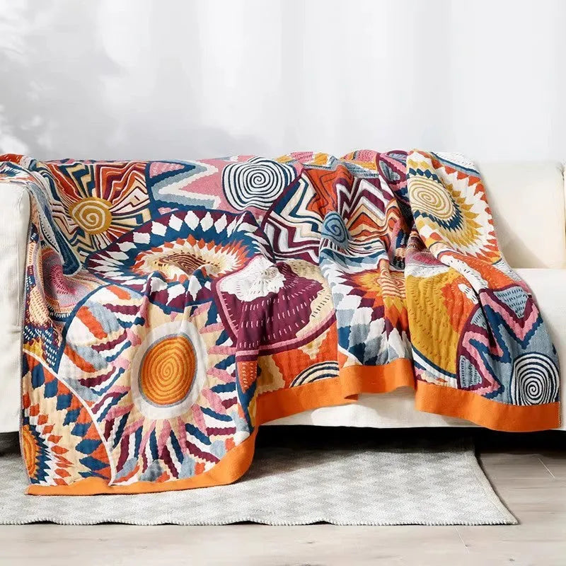 Five-layer gauze bed sheet blanket in Roulette Wheel Blue pattern on a bed