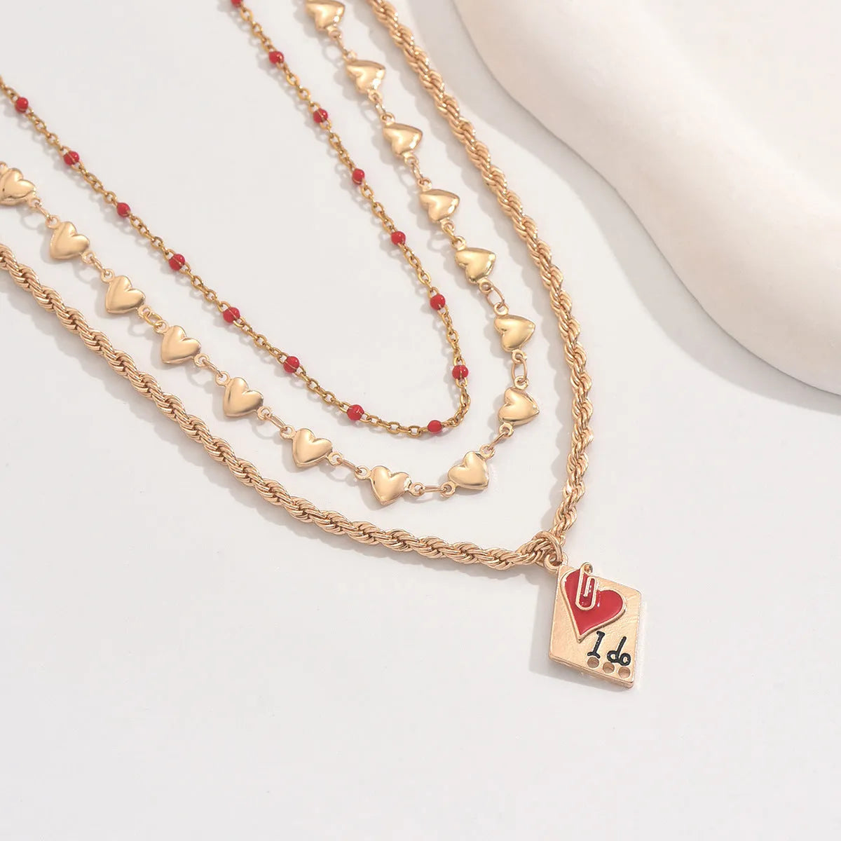 Geometric three-layer heart pendant on an adjustable zinc alloy clavicle chain necklace.