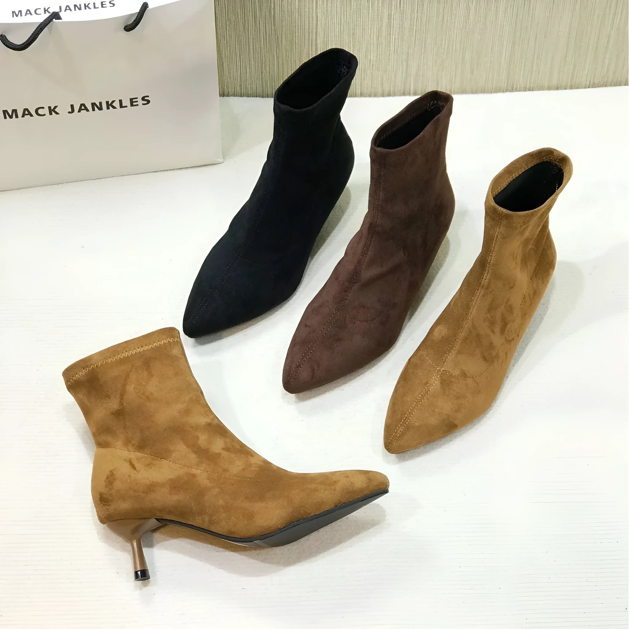 Women's black pointed toe ankle boots with a high stiletto heel on a microfiber upper.