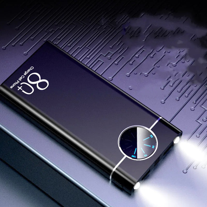 Black fast charging 20000mAh power bank with alloy shell and LED flashlight on a table.