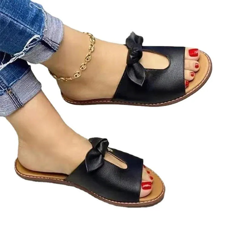 Ladies sandals with fish mouth design, bow detailing, and rubber sole in black, pink, or gold colours