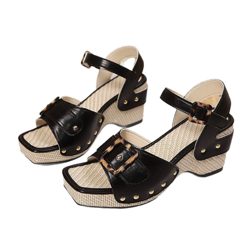 White women's sandals with a metal buckle strap and chunky block heel on a square toe.