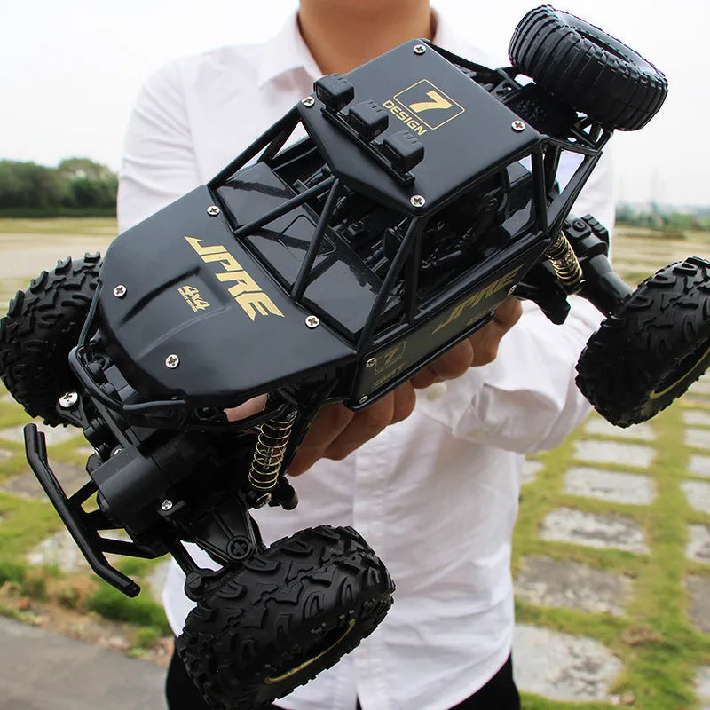 Black or silver remote control climbing car with 2.4G wireless remote on rough terrain