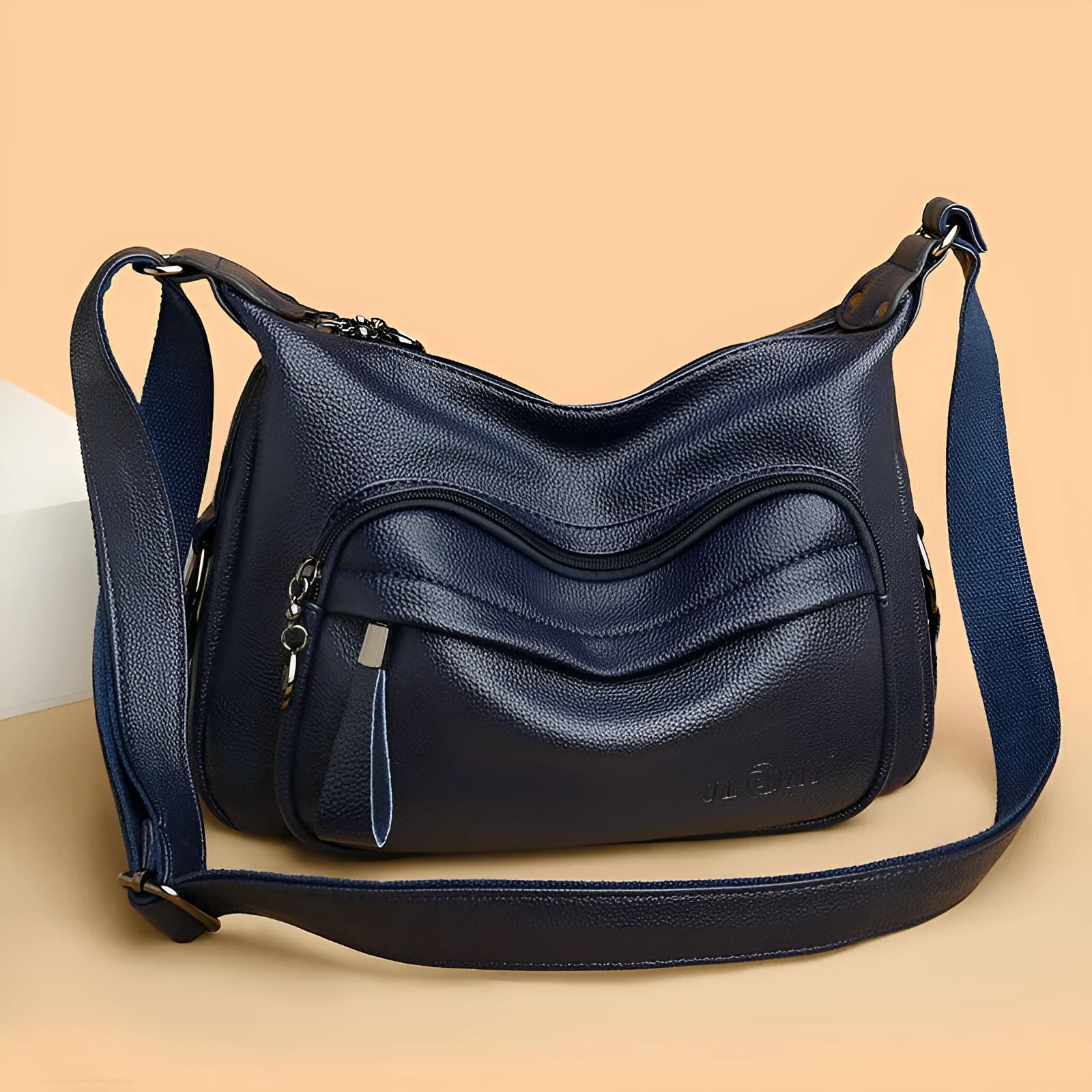 Large blue PU leather women's crossbody bag with zipper closure showing internal organiser pockets