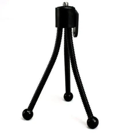 Mini tripod with universal ball head folded to 110mm size next to smartphone showing compatibility