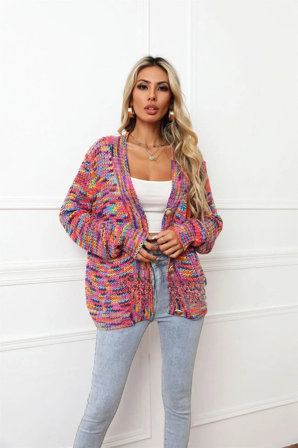 Rainbow striped loose fit knitted cardigan coat on a hanger, rose red with multicolour stripes.