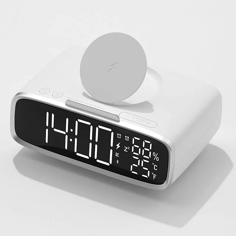 White Bluetooth speaker and wireless charging pad with integrated colour-changing night light on a bedside table.