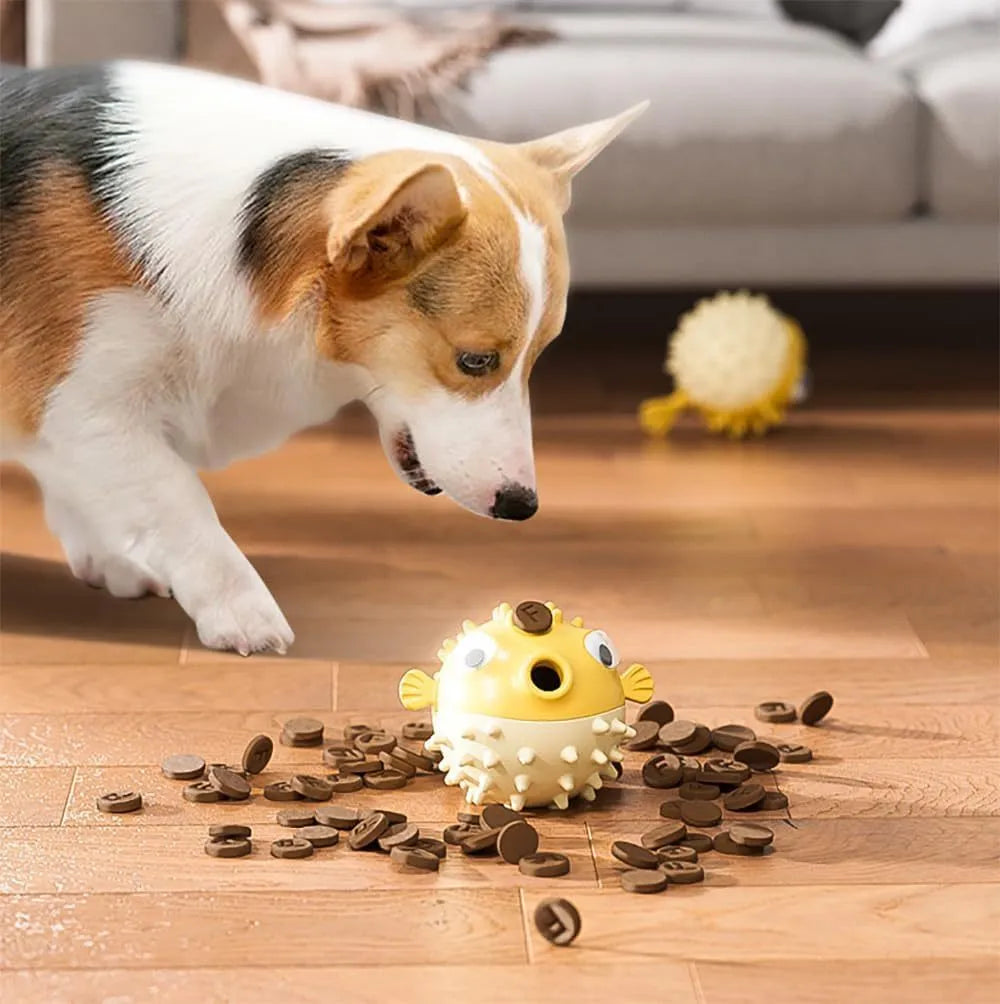 Green fish-shaped interactive dog toy with treat dispensing feature and dental cleaning particles