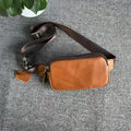Men's small leather crossbody bag in cowhide showing compact dimensions and urban simplicity styling