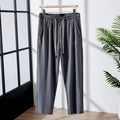 Men's loose straight-leg trousers with elastic mesh panels and ankle tie in black ice silk fabric