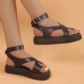 Women's white thick-soled Roman-style sandals with a buckle strap and lace loop fastening.