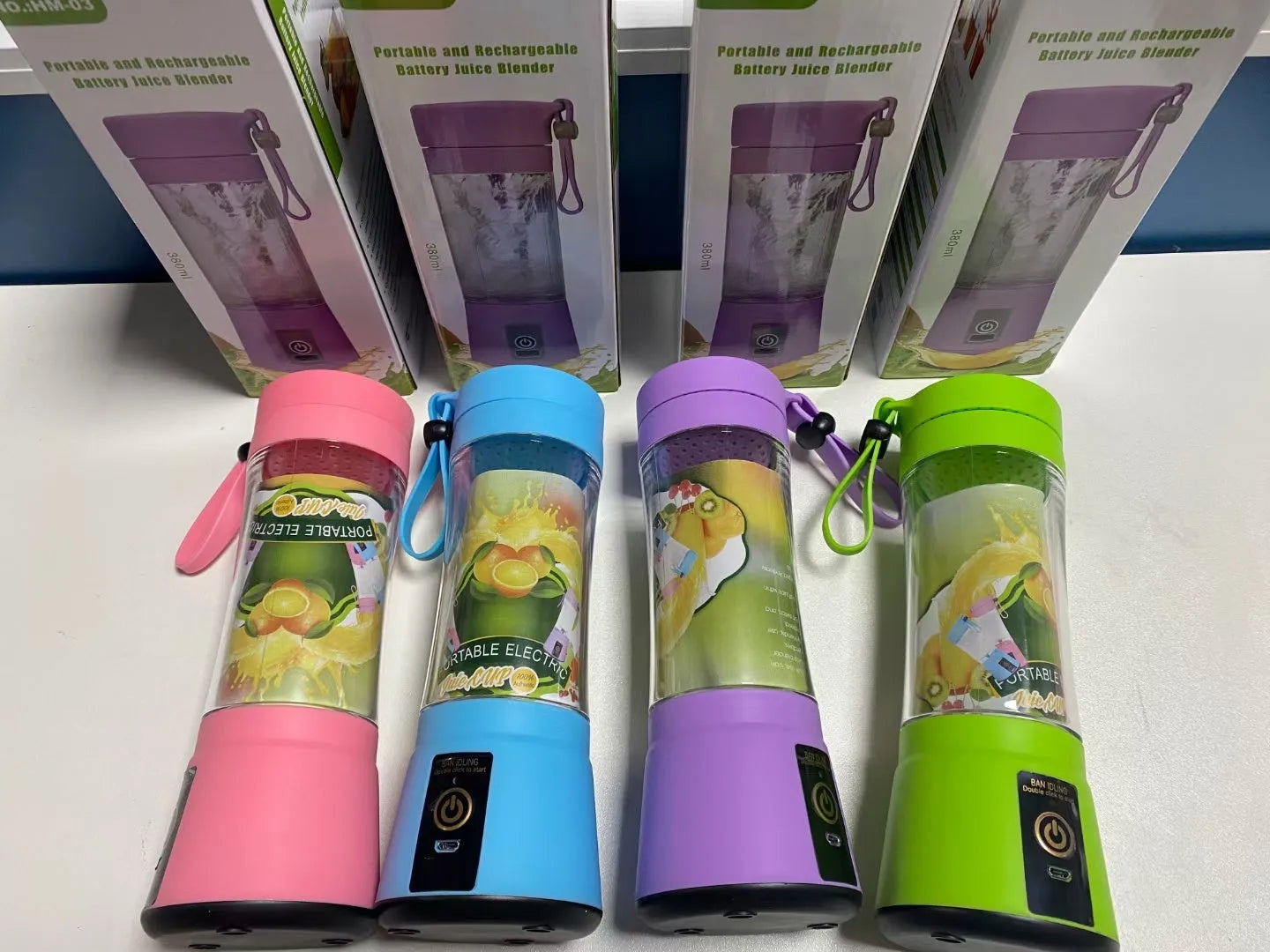 Pink portable USB blender with a transparent 380ml cup on a table, alongside a USB charging cable.