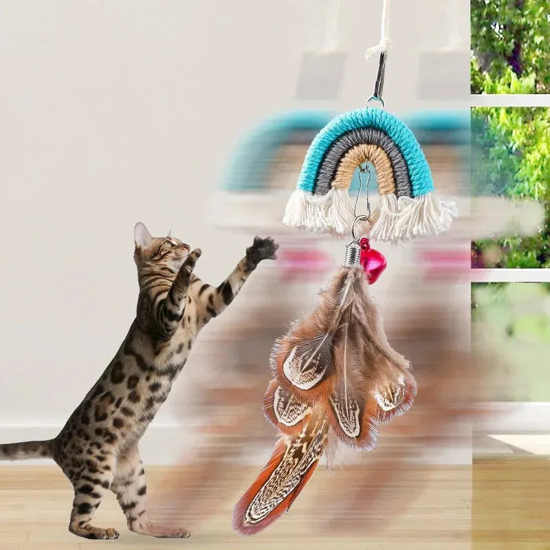 Blue feather cat rope hanging from a door on an elastic swing with a sticky buckle clamp.