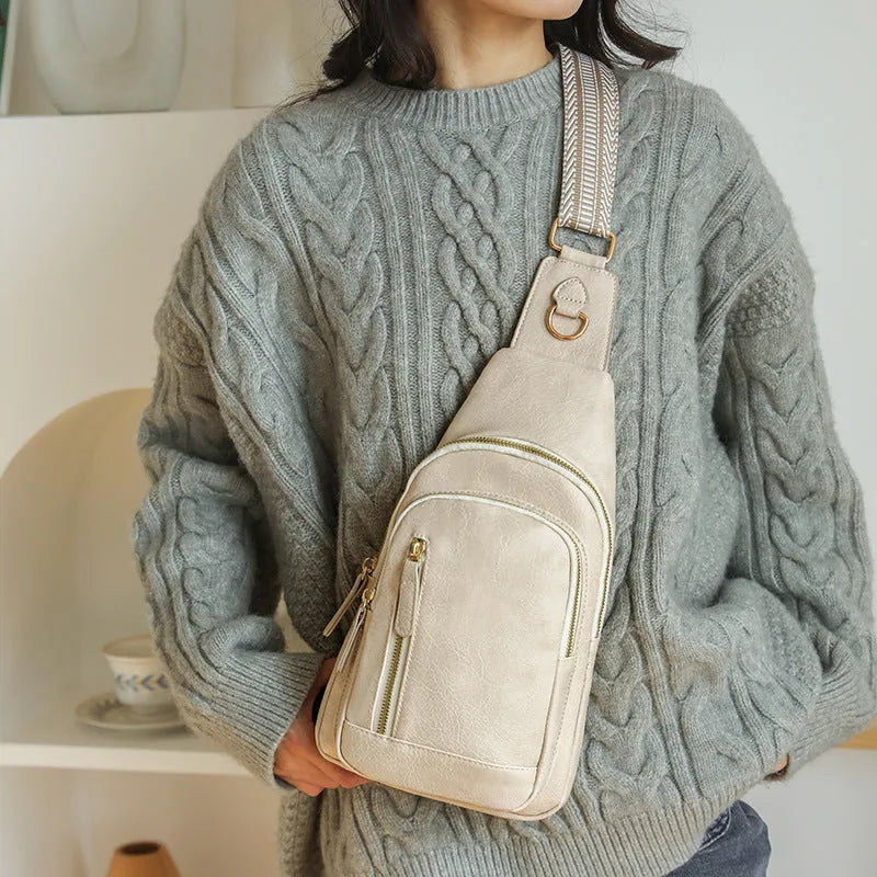 Women's soft PU chest bag in beige with open outer pocket and crossbody strap, showing sewing thread details