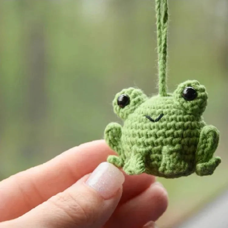 Handmade woven car pendant with small frog design, plush material, 5cm by 5cm by 15cm dimensions, available in four colours.