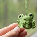 Handmade woven car pendant with small frog design, plush material, 5cm by 5cm by 15cm dimensions, available in four colours.