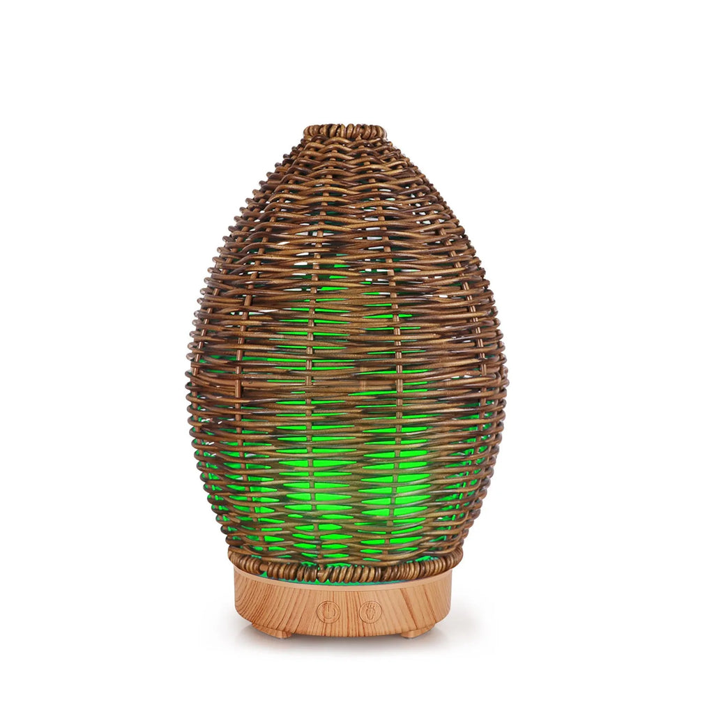 Light wood grain hollow rattan aroma diffuser with 100ml water tank on a wooden surface.