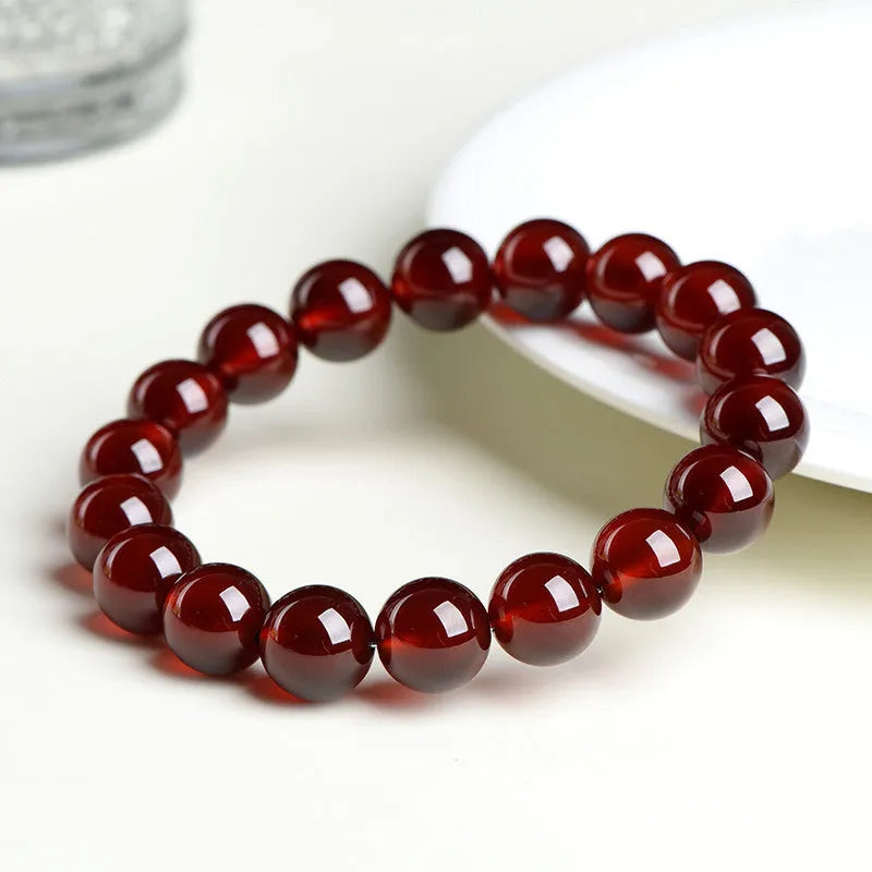 Natural orange red garnet crystal ball bracelet with retro Ruyi design on wrist