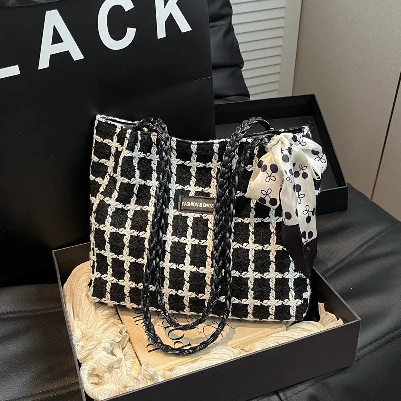Black woolen shoulder bag with horizontal square shape showing internal organisation compartments