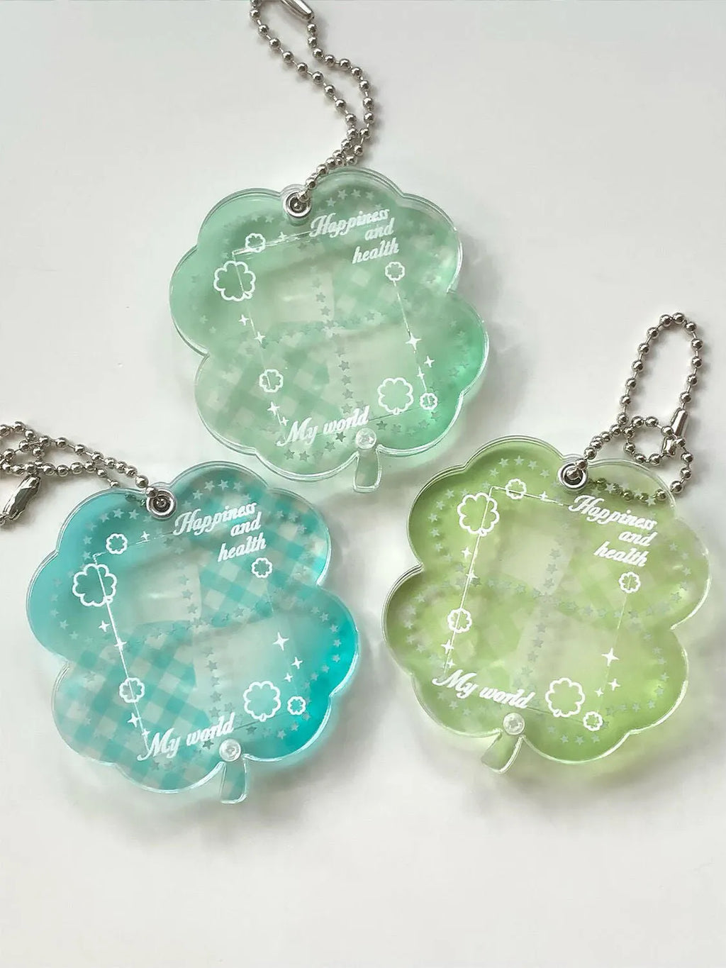 Blue, green, and mint green four-leaf clover acrylic phone pendant keychain.