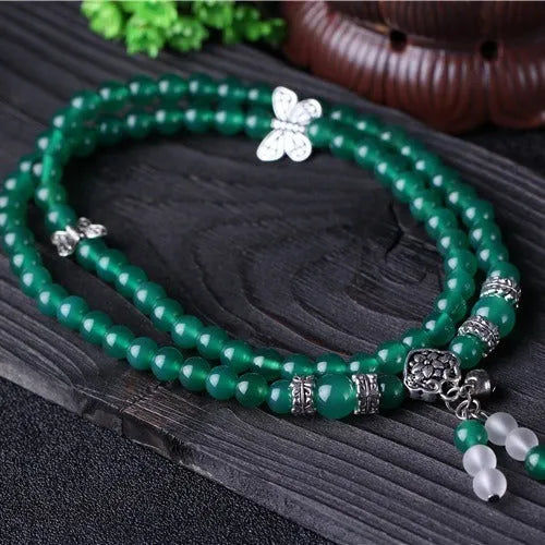 Close-up of a green agate multi-layer bracelet with three strands of 6mm round beads.