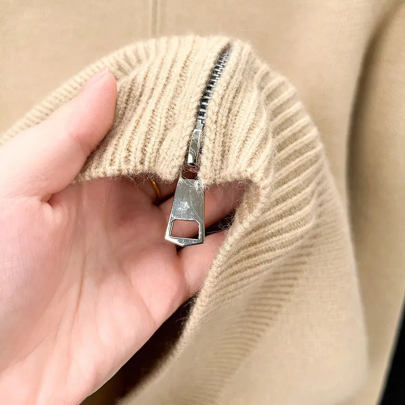 Man wearing a beige high collar knitted cardigan with a full-length front zipper, showing loose fit.