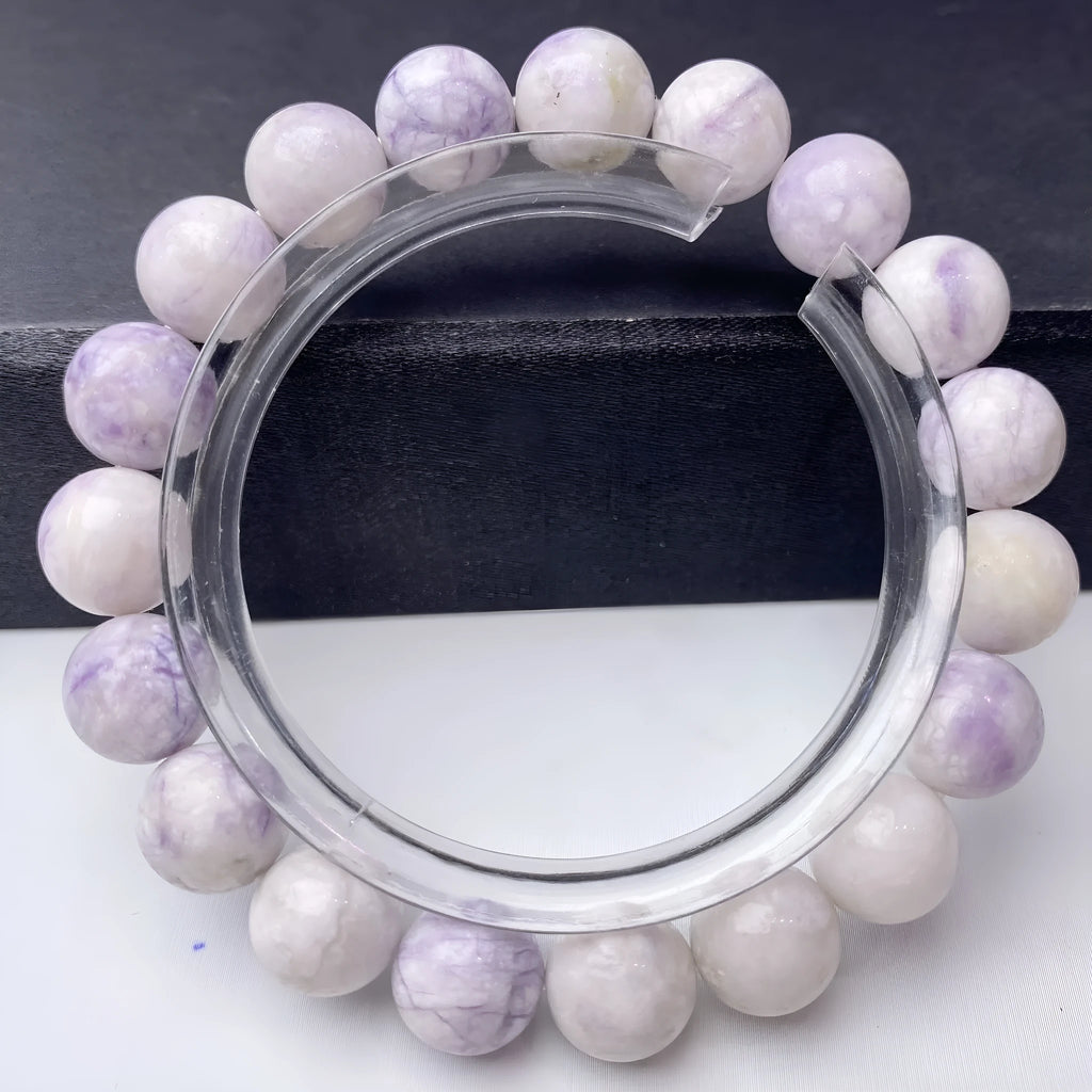 Natural purple turquoise bead bracelet for women on a white background, showing adjustable string tie.