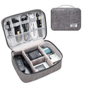 Black electronics organiser bag with mesh pockets and removable dividers for cable storage