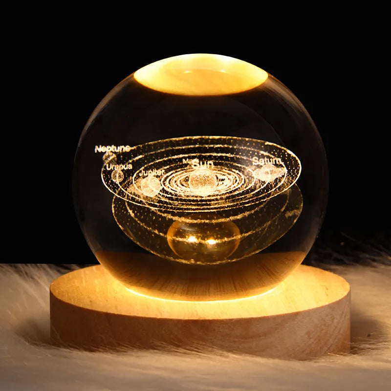 3D crystal ball night light projecting starry sky and planets from its 6cm sphere on a solid wood base.