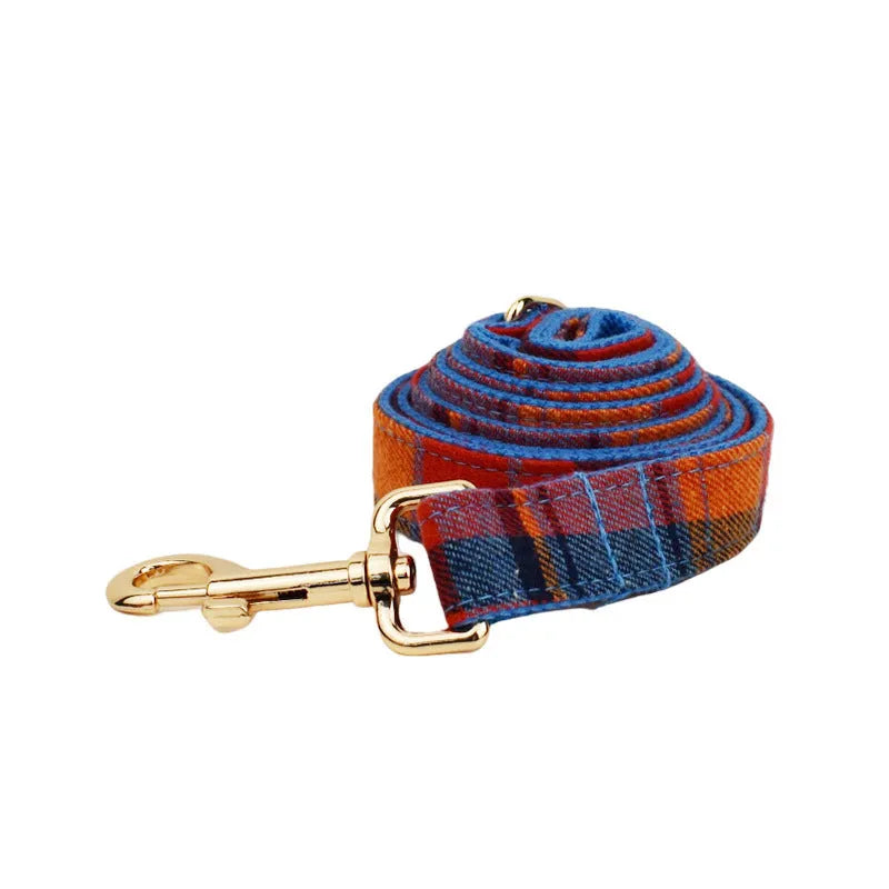 Dog accessory four-piece set showing collar, leash, vest, and bow tie in cloth fabric