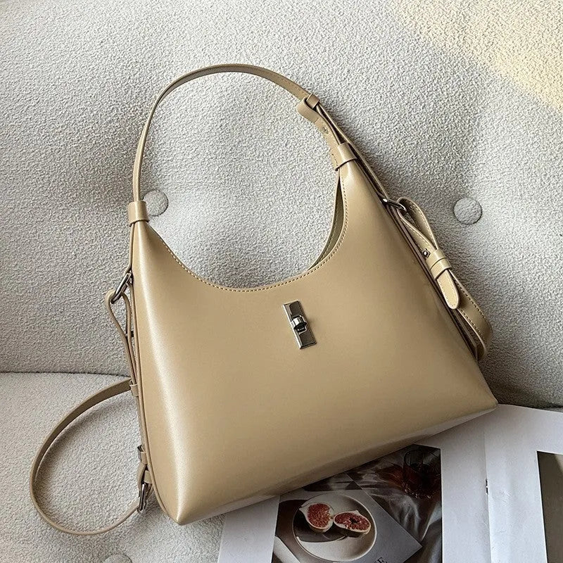 Genuine leather crossbody shoulder bag with dumpling shape, internal organisation pockets, and street trend style details