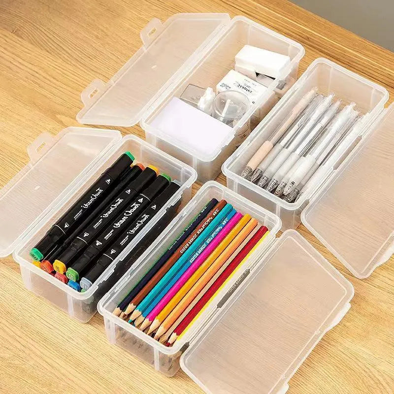Transparent plastic stationery storage box with snap-lock lid containing coloured pencils and pens
