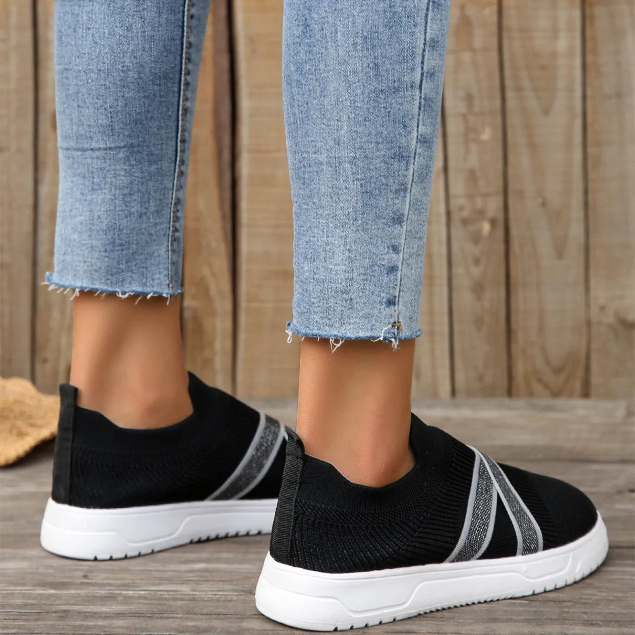 Women's black flyknit mesh casual shoes with flat rubber sole and tassel detail