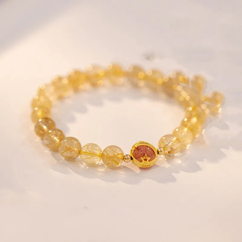 Gold rutilated quartz crystal bracelet with diamond-cut beads on stretch cord in Korean style