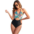 Women's black one-piece swimsuit with a printed red, yellow, and green patchwork leaf design.