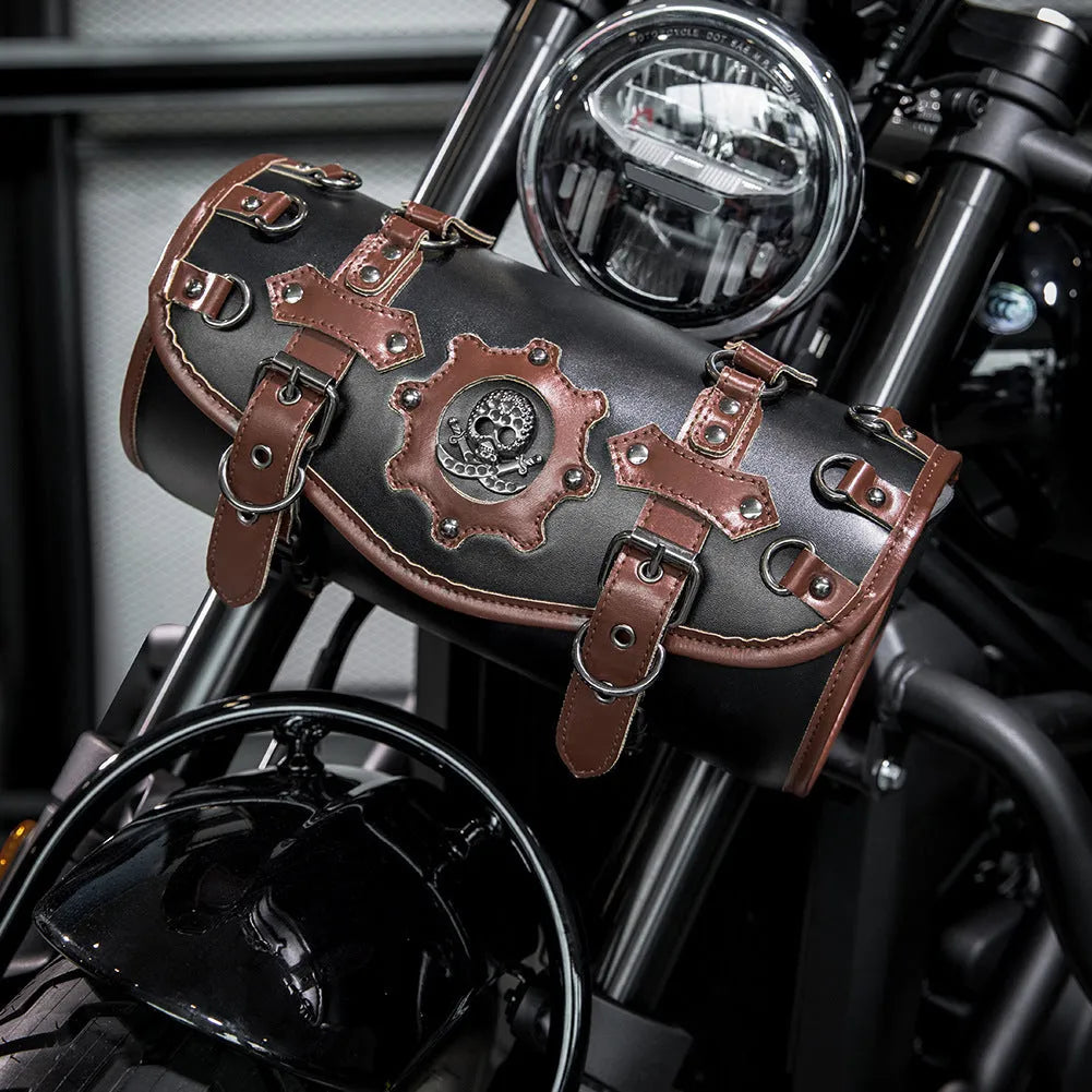 Black PU motorcycle pannier bag with punk retro styling mounted on a custom bike.