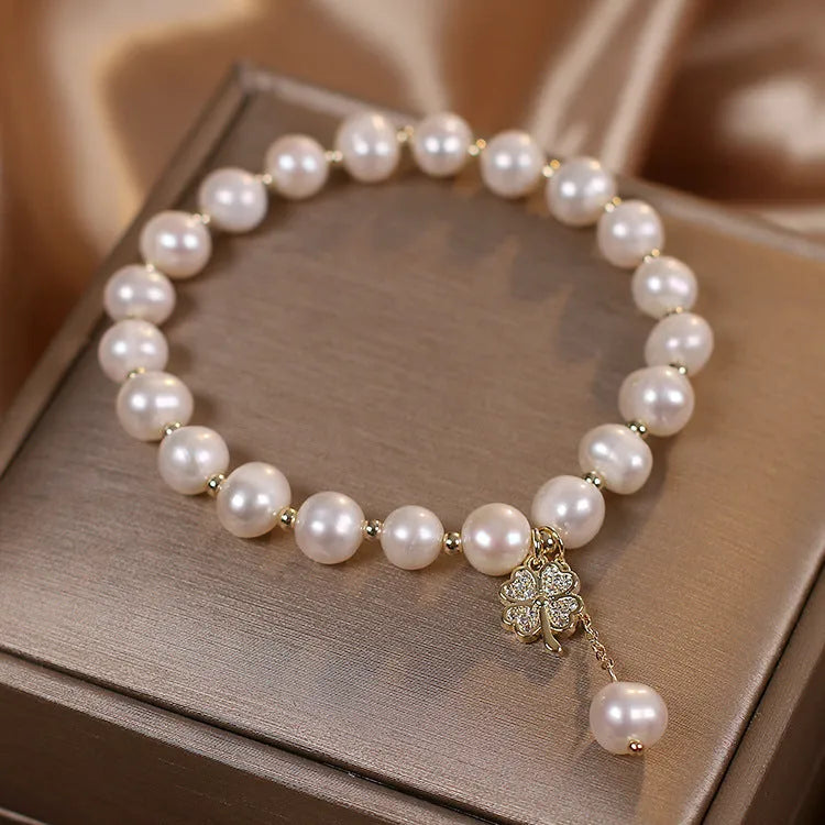 White freshwater pearl bracelet with four-leaf clover charm, alloy material, and sequin detail for women